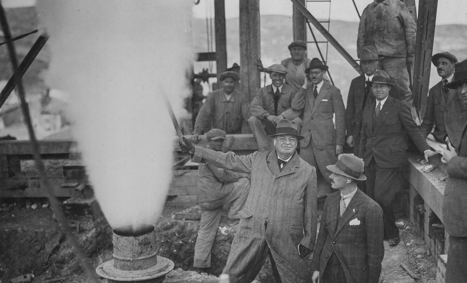 Men in black and white build geothermal power plant