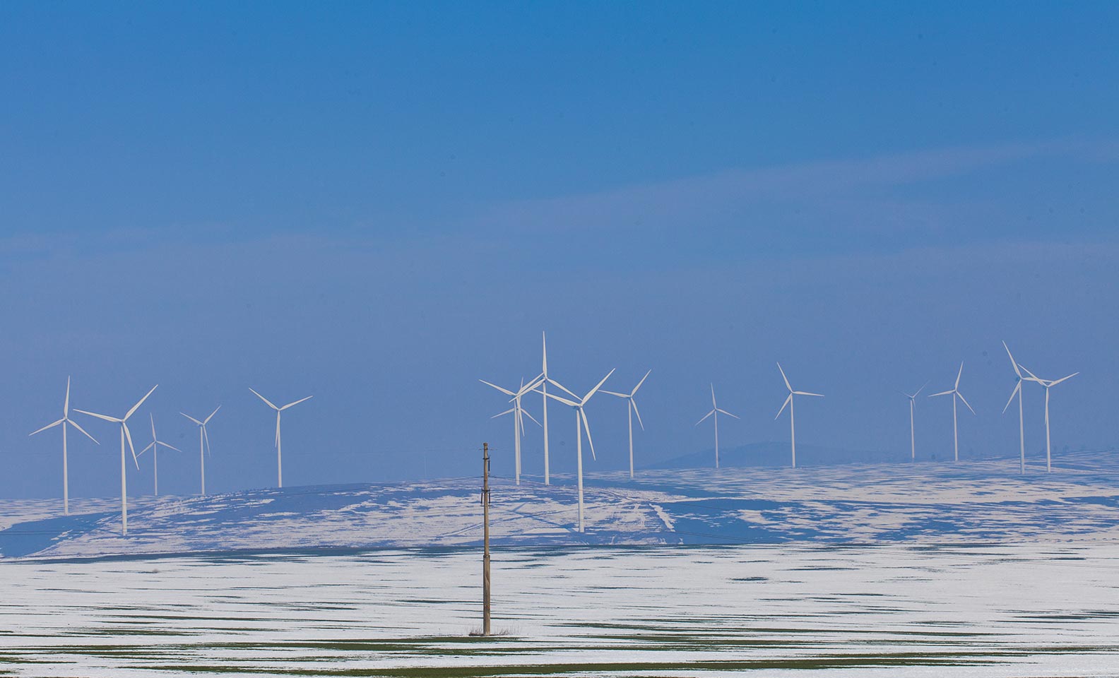 Wind turbines on snowy landscape