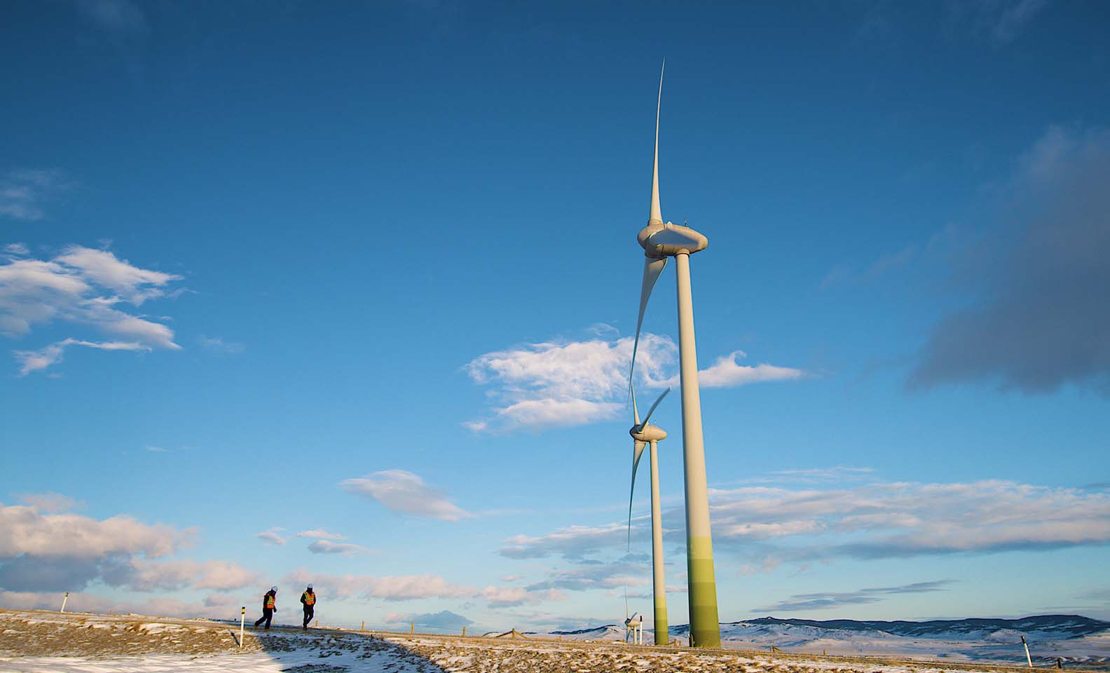 Wind turbines on snowy landscape and view on EGP operators